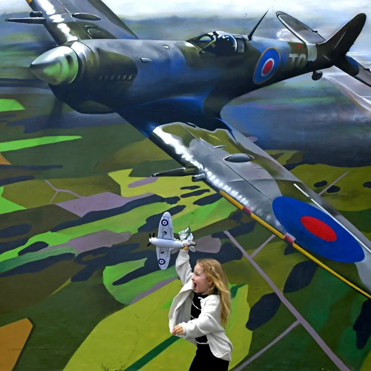 Full page spread in The Daily Star and Times Online.
Ayla Halford, 5, plays in front of a new mural painted on the side of The Victoria, a pub in Woolston, Southampton, Hampshire.
The Spitfire painting was commissioned by Ayla's grandmother and lan