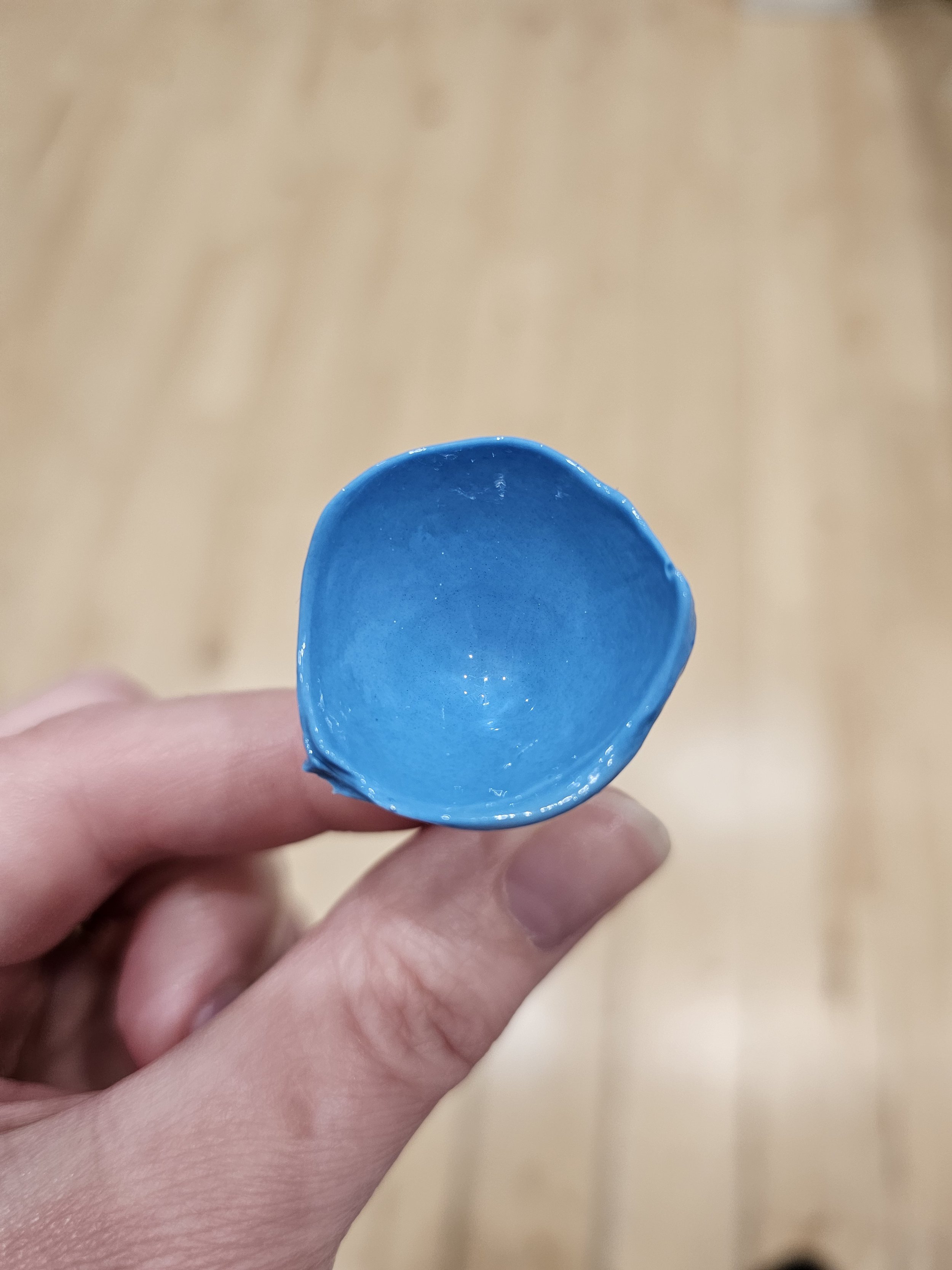 A person holding an Eyeprint Pro impression of an eye, ready to be scanned to have a bespoke contact lens made.