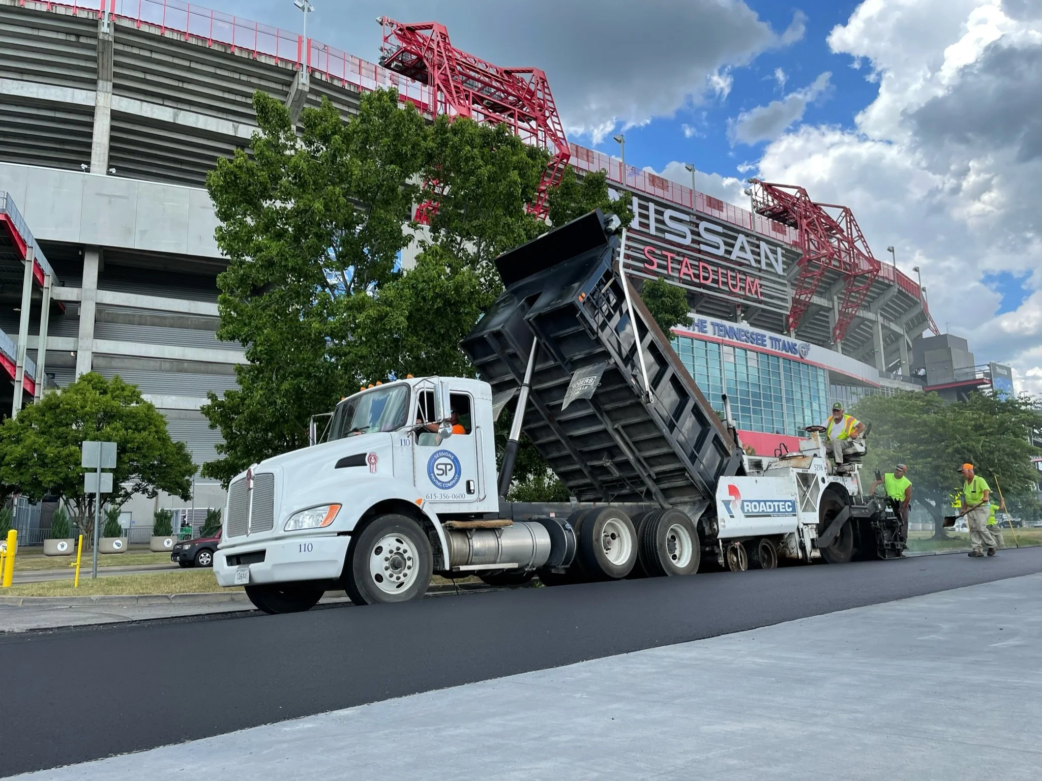 A Dump Truck in Nashville paving the Pit Lane Road of the Music City Grand Prix