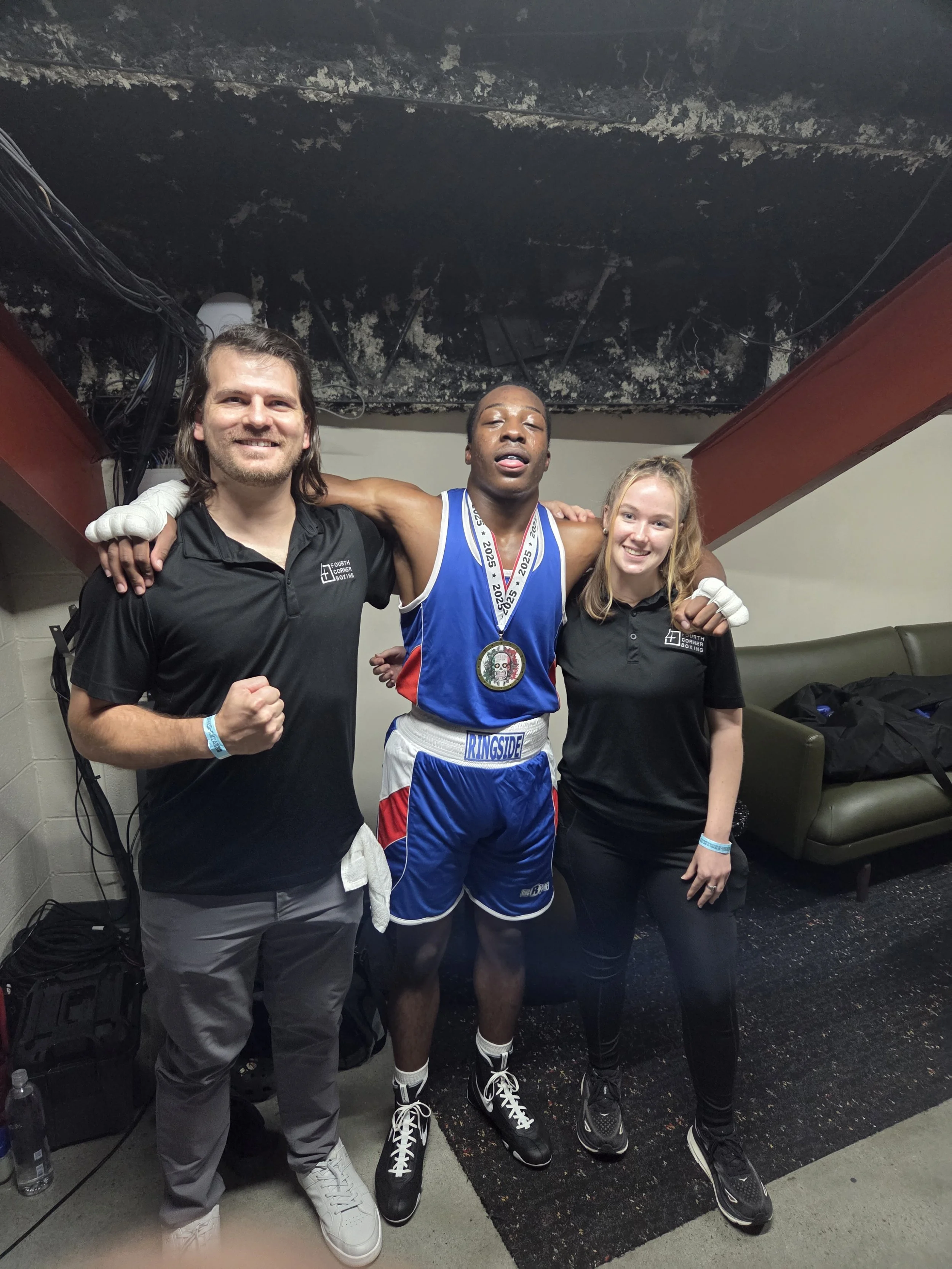Coach Damien with his assistant coach and boxer after his boxing match