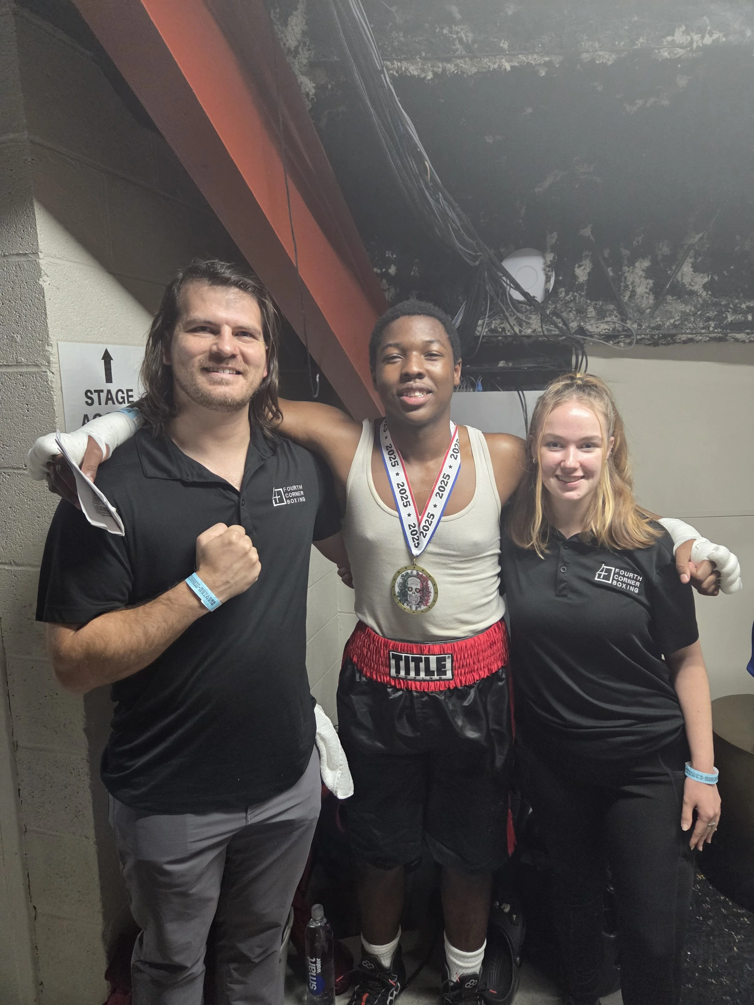Coach Damien with his assistant coach and boxer after his boxing match