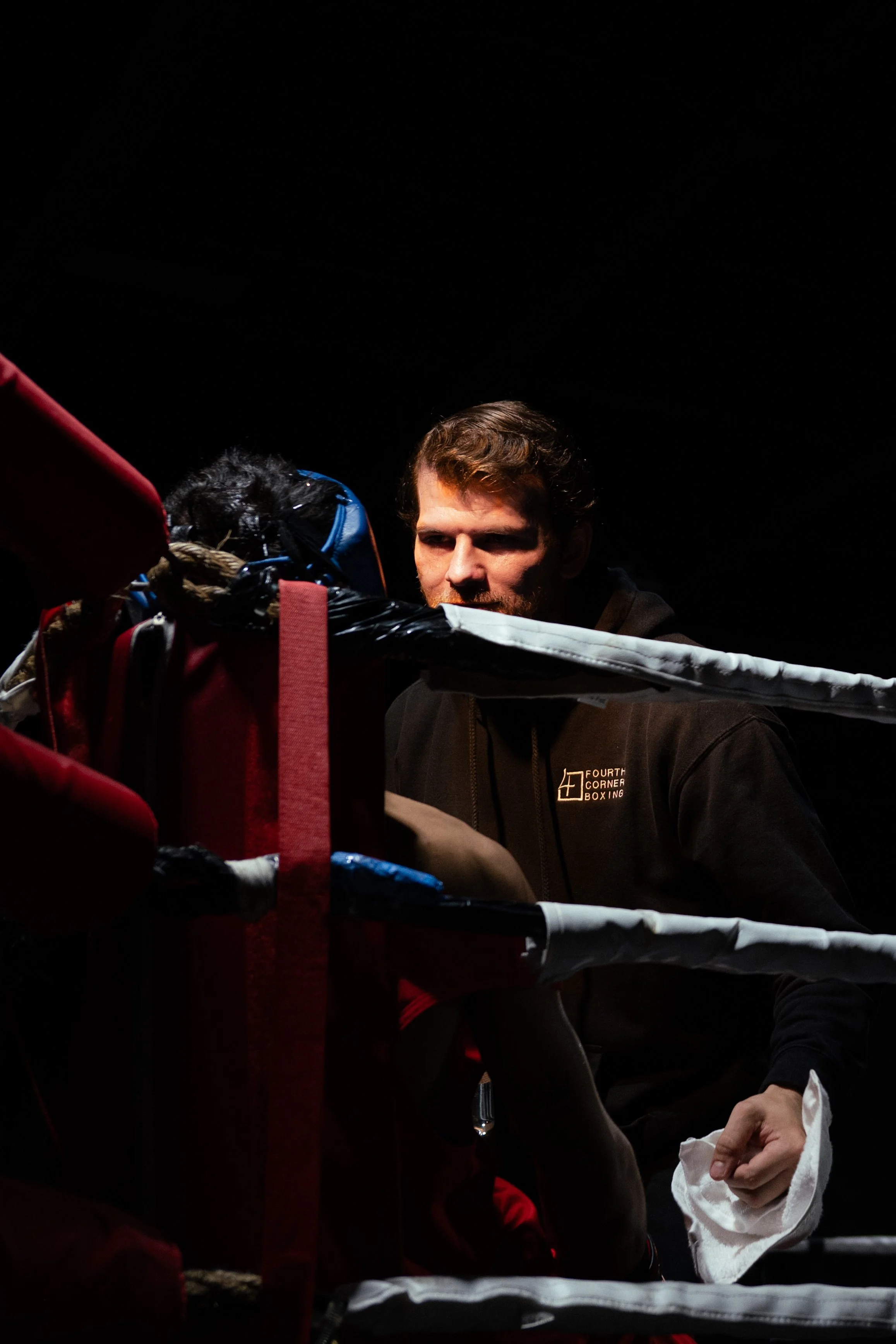 Coach Damien giving advice between rounds of a boxing match