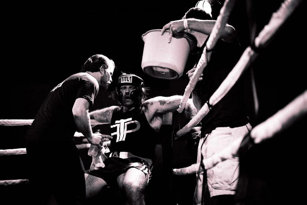 Coach Damien giving advice between rounds of a boxing match