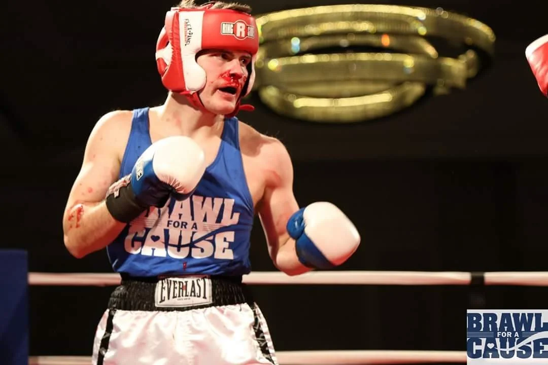 Coach Damien with a bloody nose in a boxing match