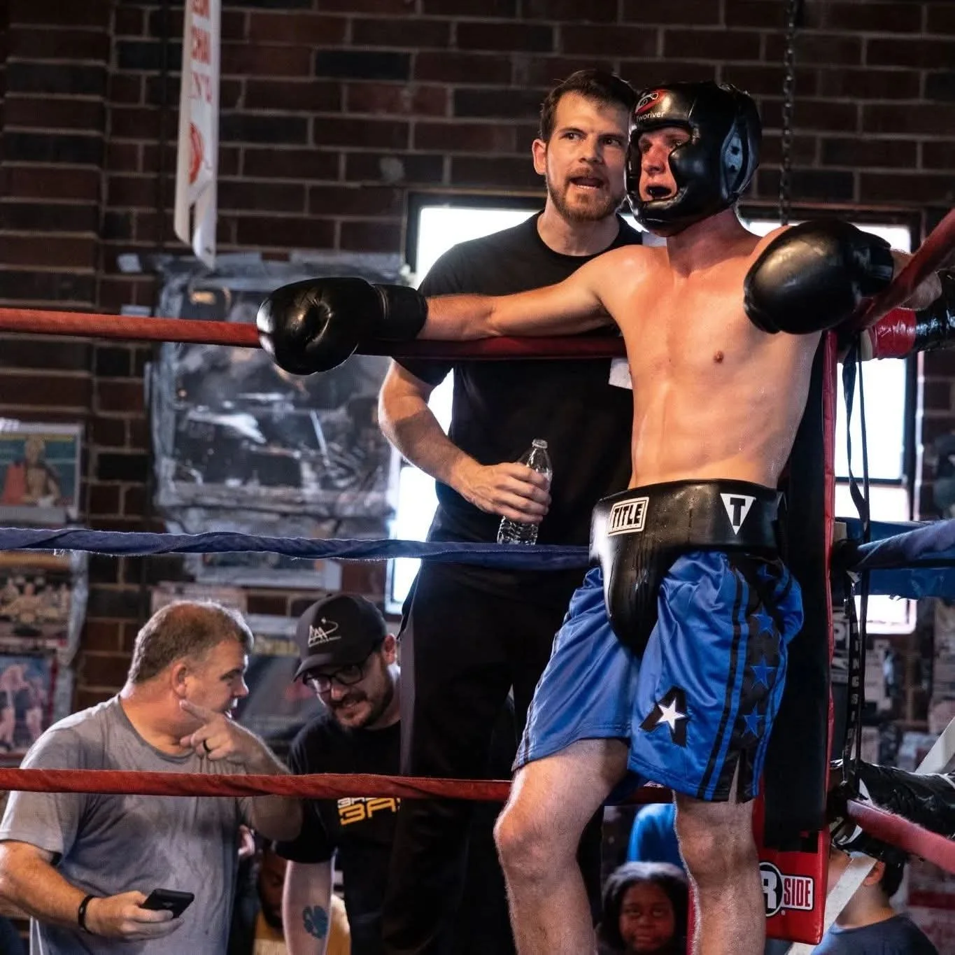 Coach Damien giving advice in the corner of a boxing match
