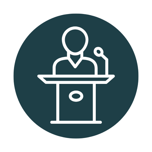 Icon of a person speaking at a podium with a microphone.