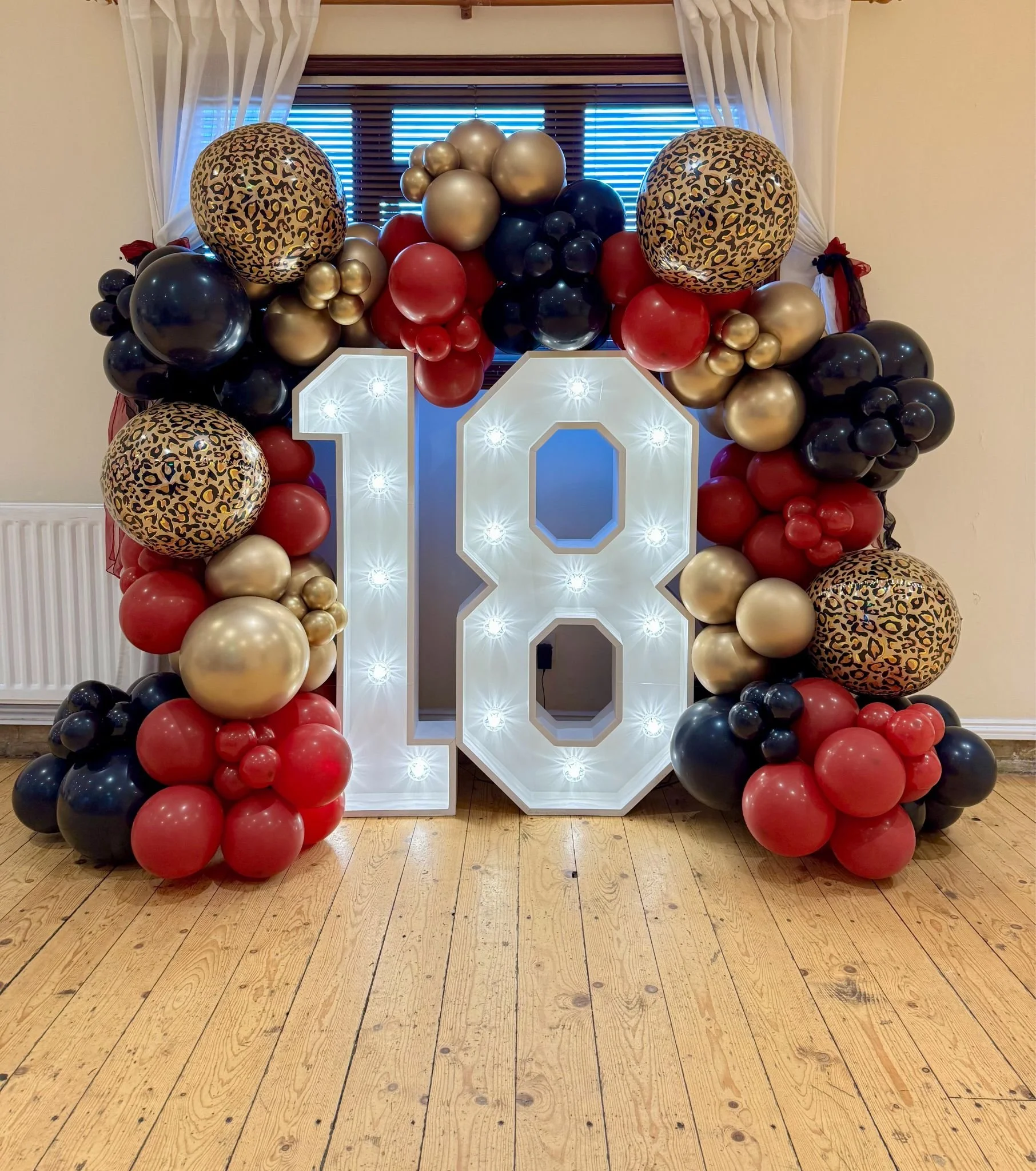 balloon garland leopard , red , black and gold with light up numbers Herts