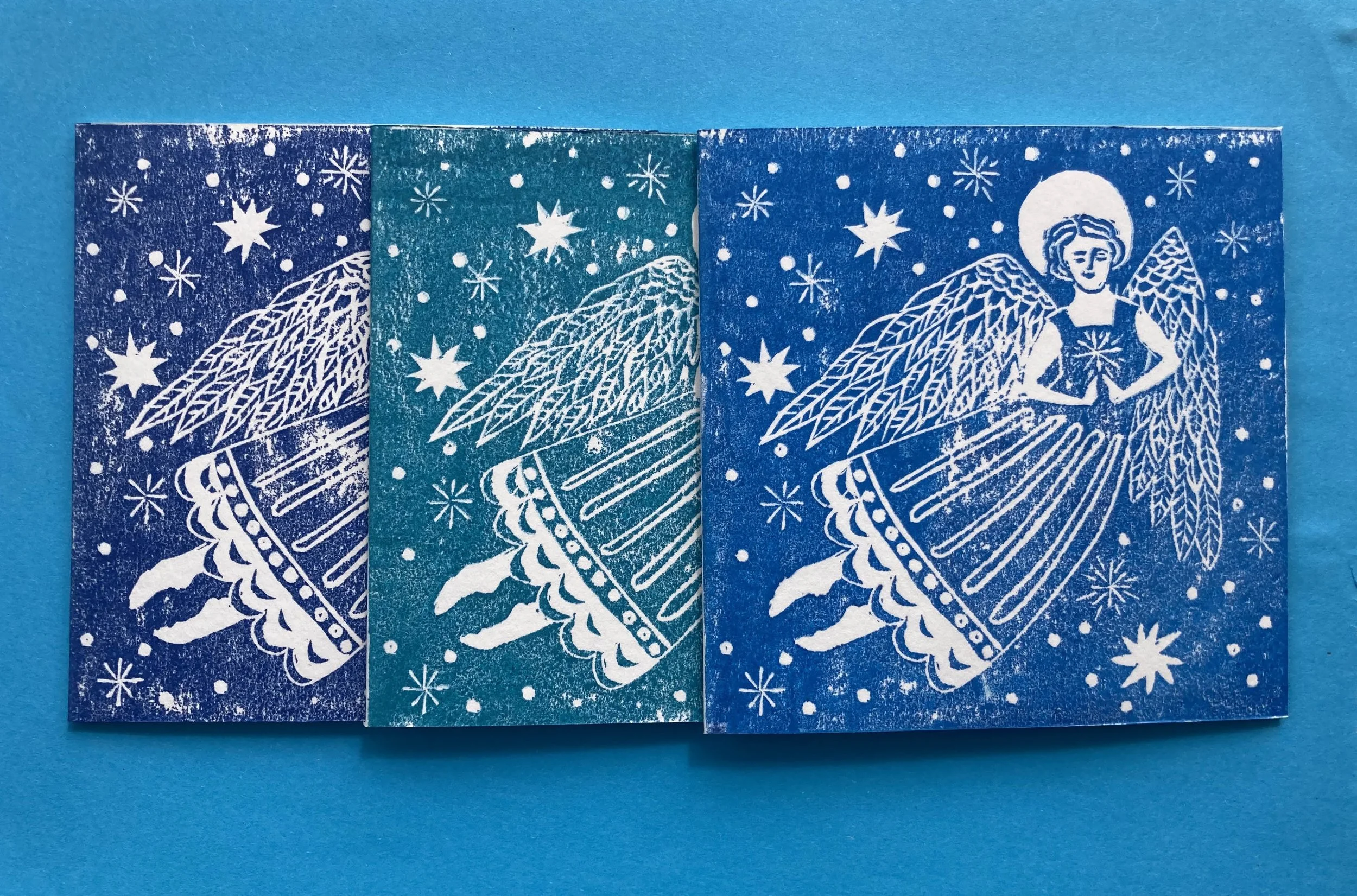Delicate Christmas card linocut print design featuring cheerful angel