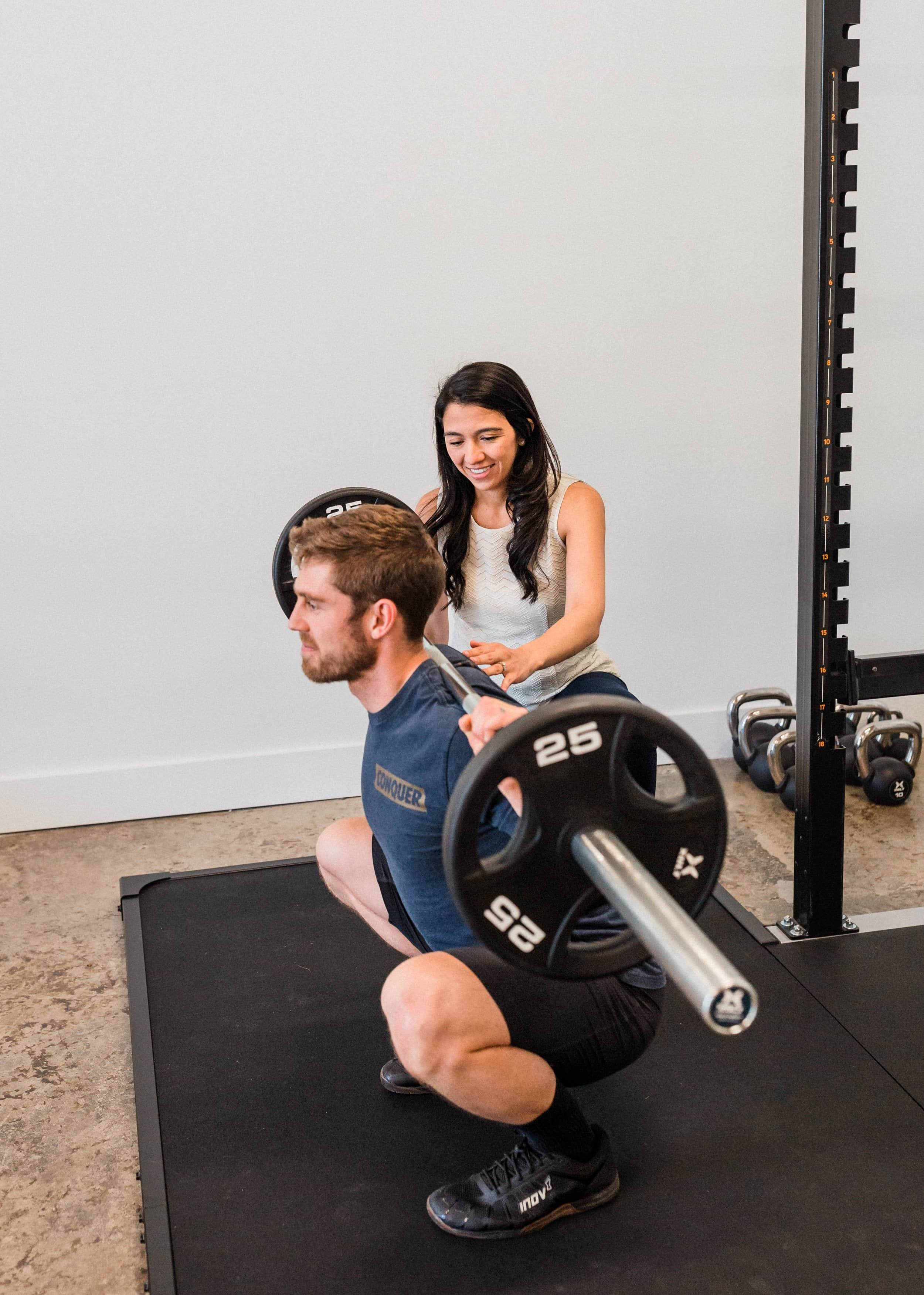 Man squatting with barebell