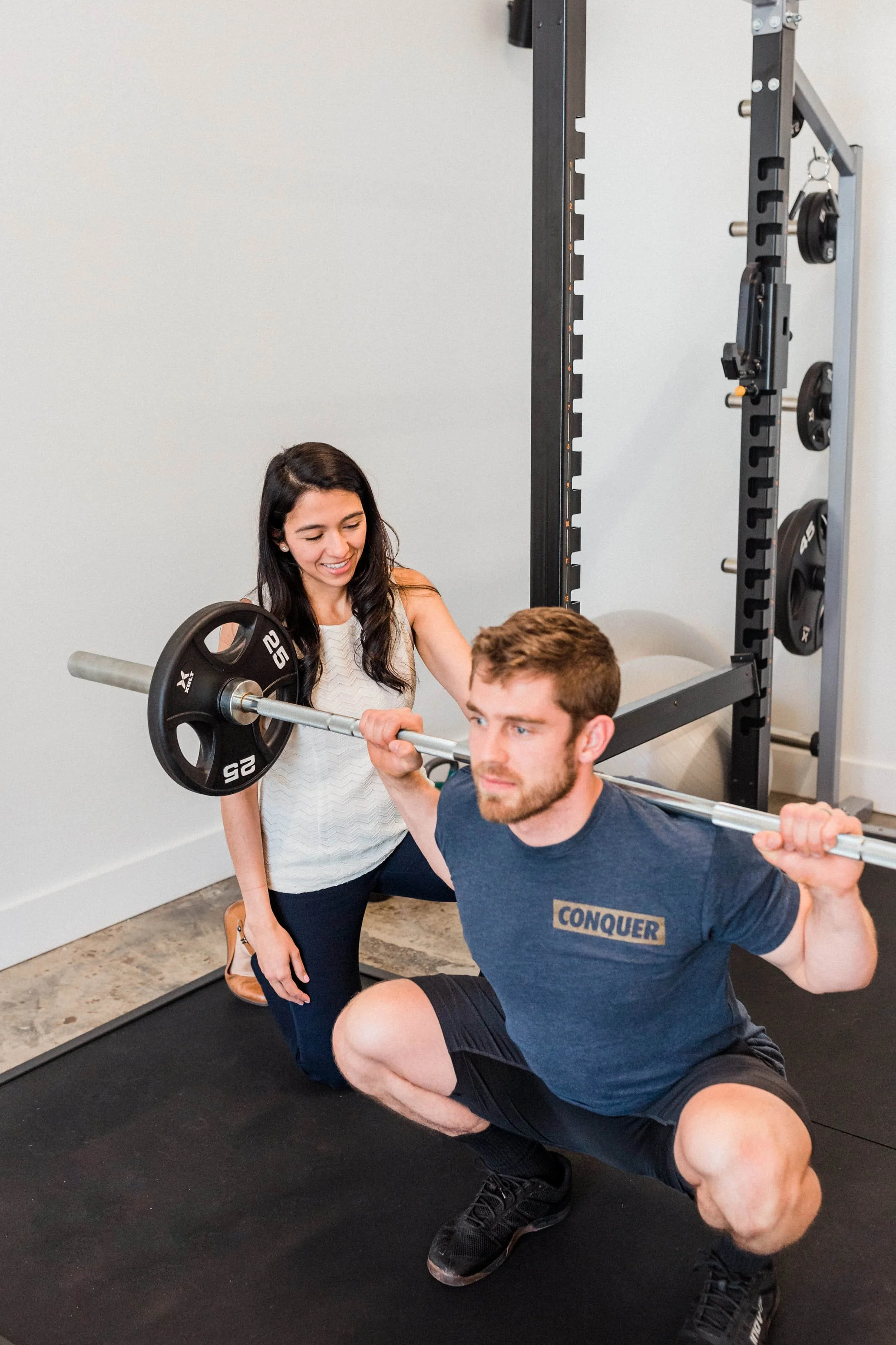 Man squatting with Barbell 