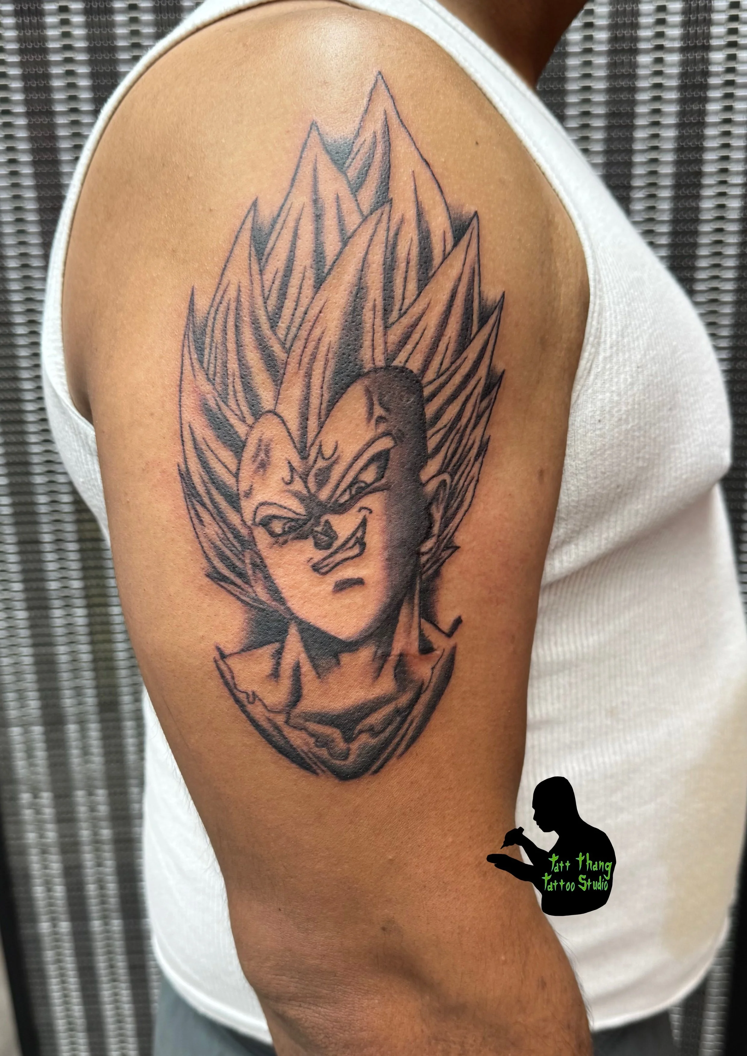 Tattoo of a character Vegeta from Dragon Ball series, on a person's upper arm.