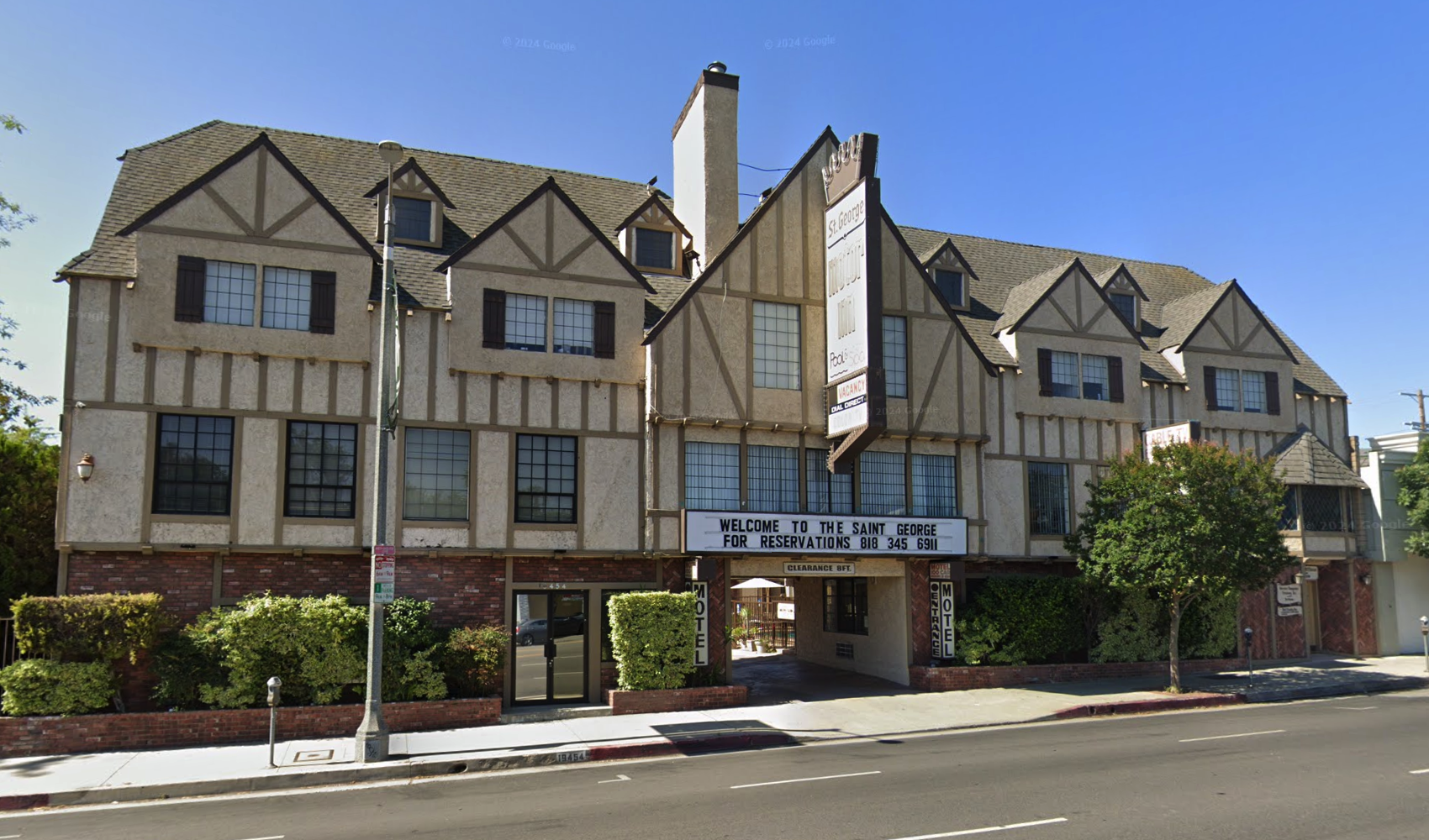 Front exterior of St. George Motor Inn in Tarzana, California, a Tudor-style multi-story building on Ventura Boulevard in daylight.