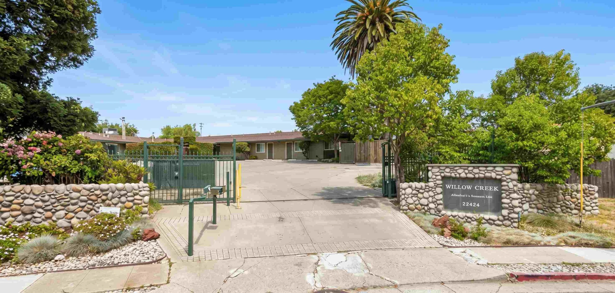 the landscaped grounds and walking path at Willow Creek memory care community on Charlene Way in Castro Valley, California