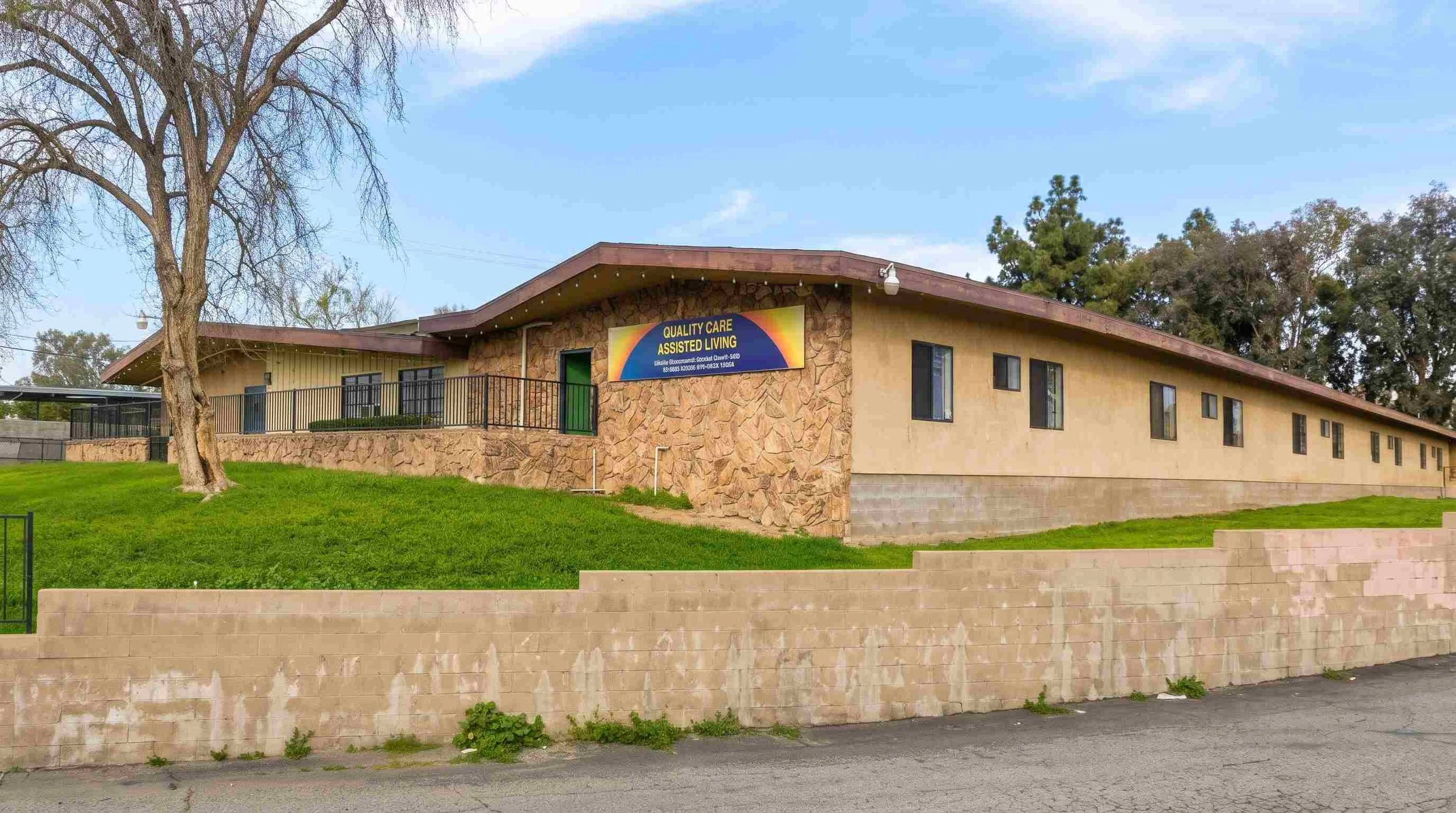 Front entrance and shaded walkway of an assisted living community in East Bakersfield