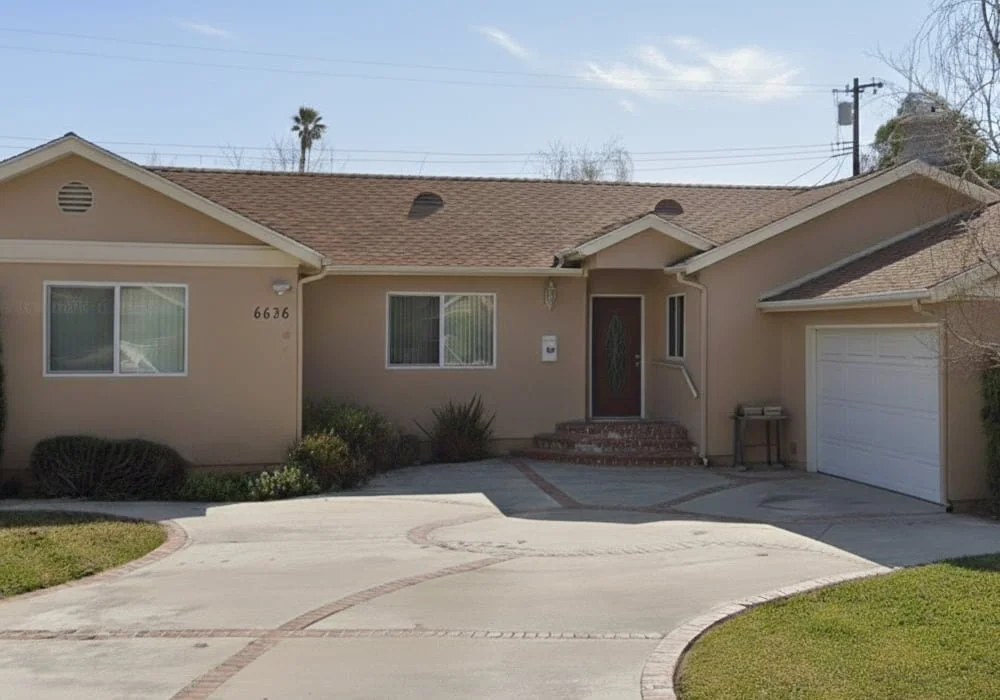Exterior view of Land of Peace 2 Assisted Living, a single-story beige residential care home with a driveway and front entrance located at 6636 Sale Avenue in West Hills, California.