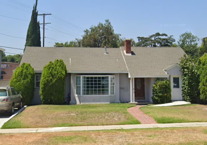 Front exterior of Angel Life Care residential care home with single-story house and front yard