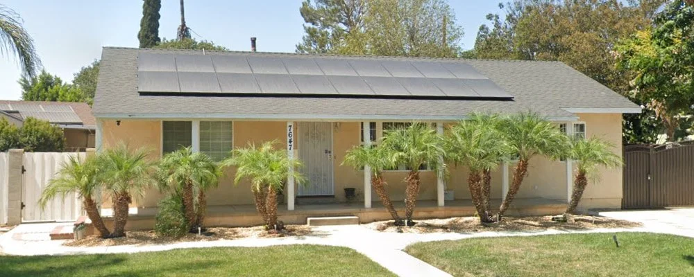 Exterior view of Balboa Assisted Living Inc residential care home with landscaped front yard and solar panels