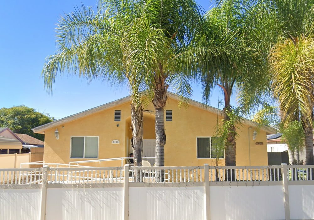 Exterior view of Ano One Facility for the Elderly in Panorama City, California, a single-story assisted living home with palm trees and a fenced yard