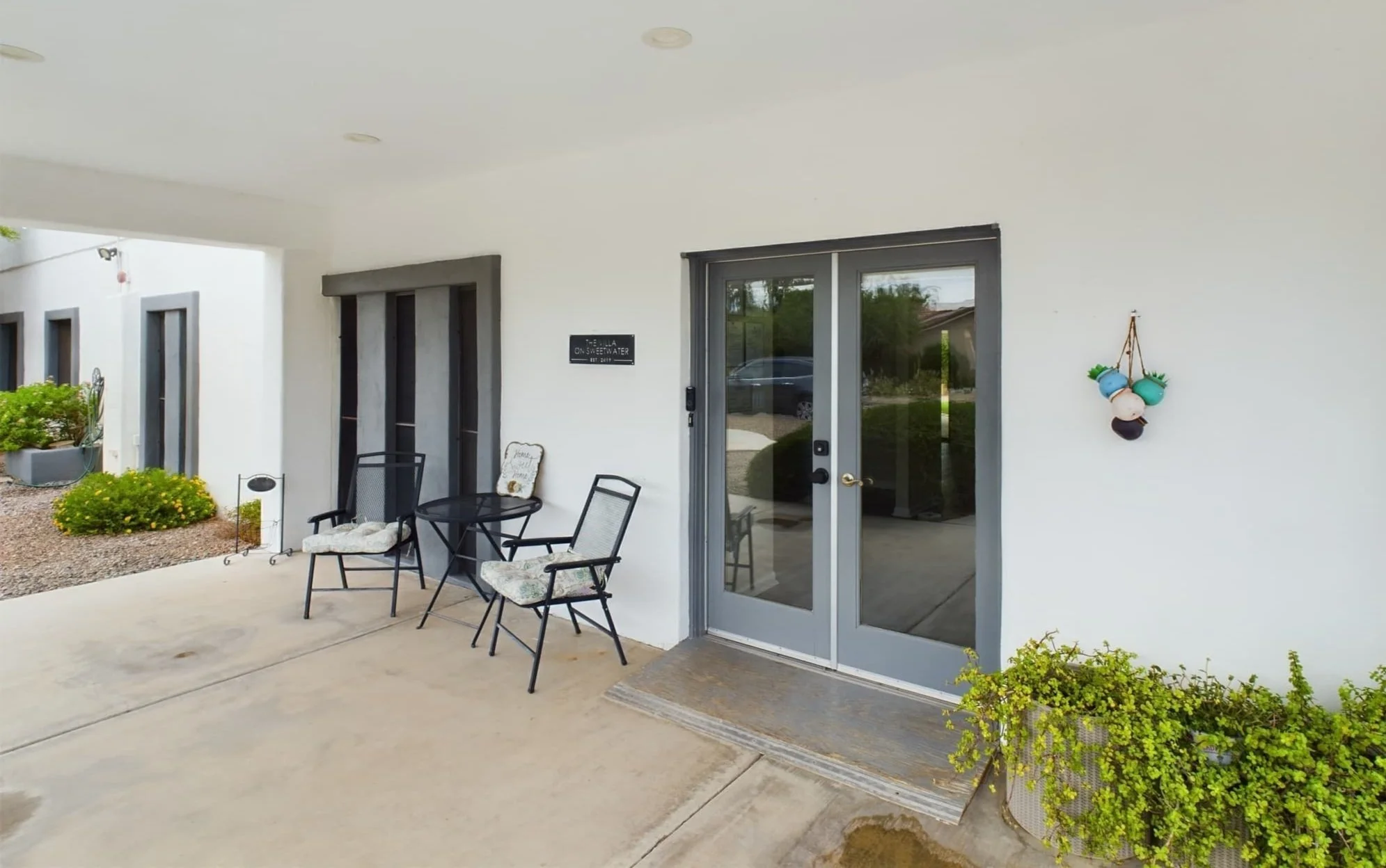 Covered front patio with seating area at Well Heeled Adult Care Sweetwater, LLC, showing a calm and welcoming residential entrance for seniors in Scottsdale.
