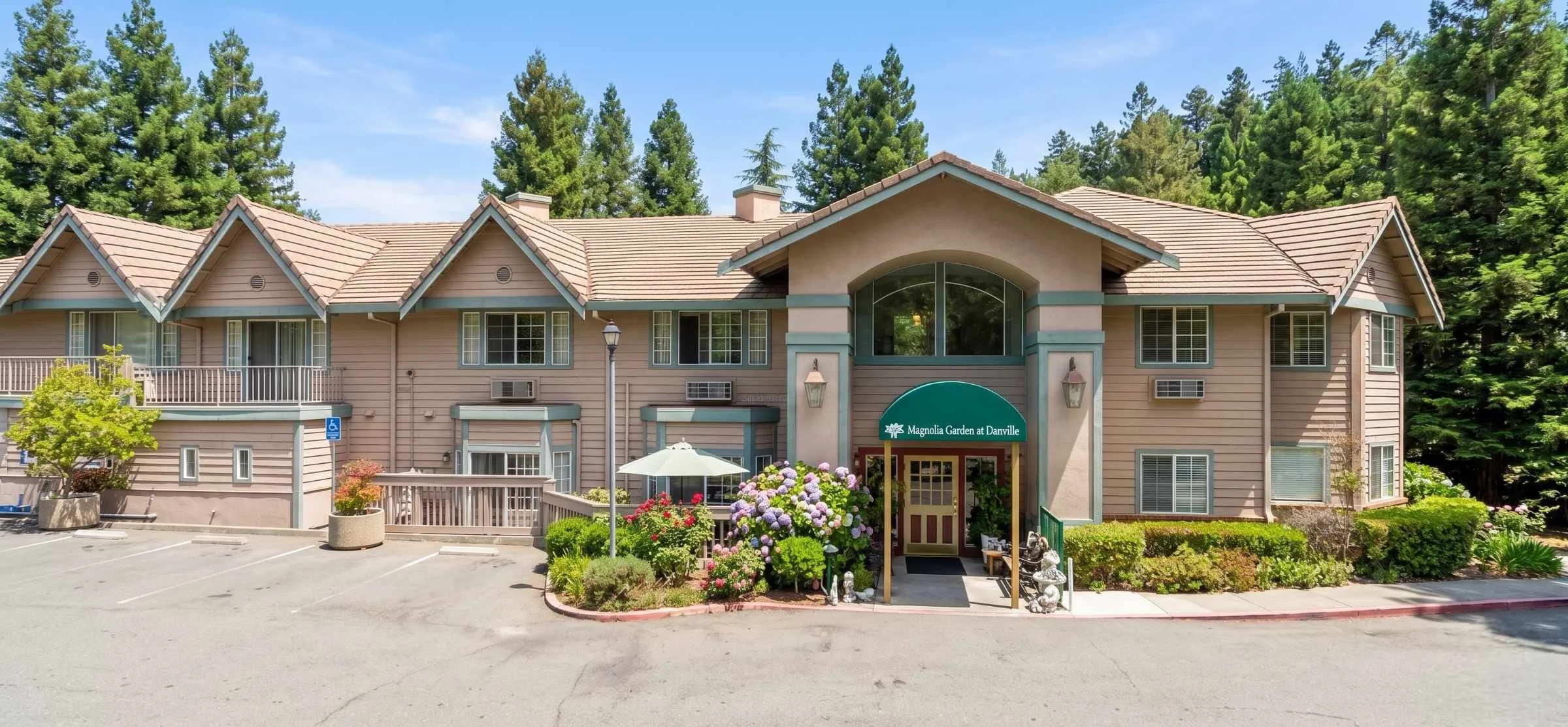 Front view of a small suburban senior living home with a garden and porch in Danville, Contra Costa County