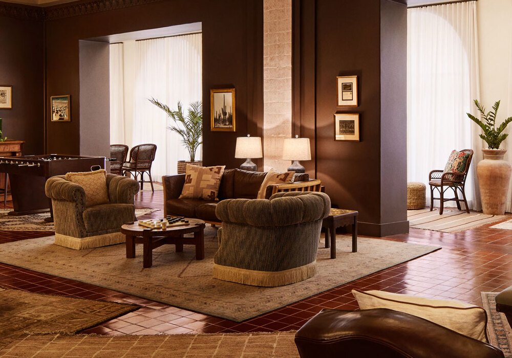 Elegant lobby of Pasadena Hotel & Pool with classic armchairs, warm lighting, and cozy seating areas