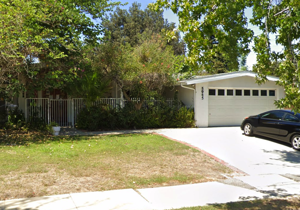 Front view of AAA Jerusalem Stars residential care home at 5945 Capistrano Ave in Woodland Hills, California, showing the gated entrance, driveway, and trees in front yard.