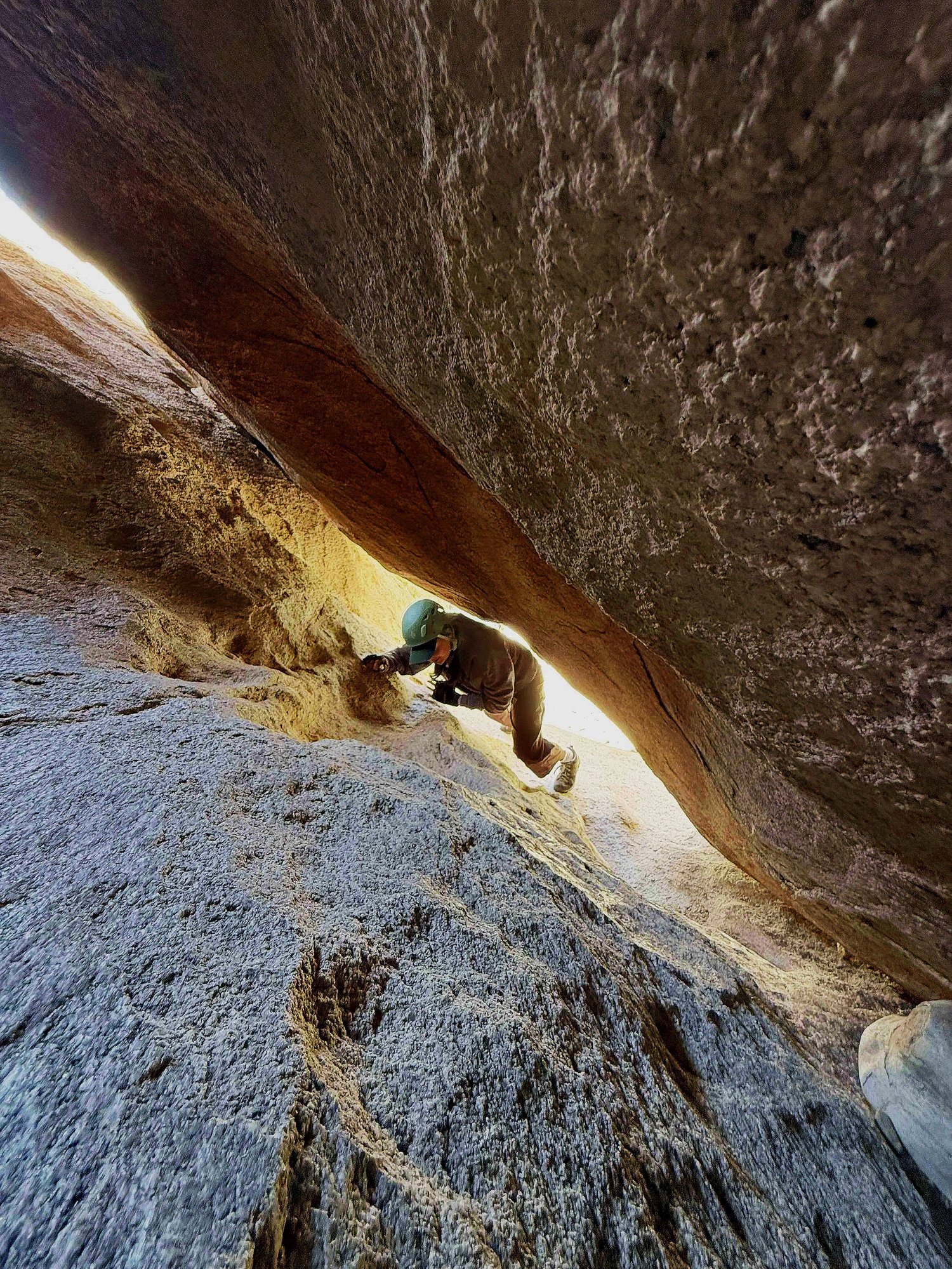 Entrance to a tight S3 cave passage at Mad Hatter in Joshua Tree National Park