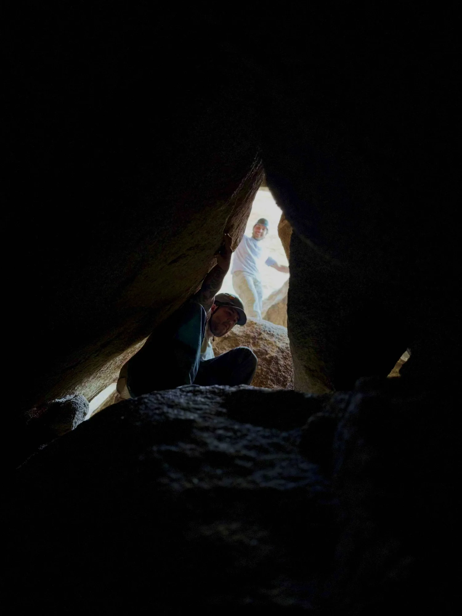 Summit Climbing Guides guest deep inside an S5 Full Send cave squeeze in Joshua Tree