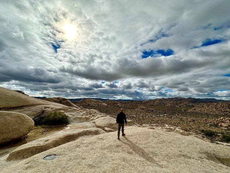 Climbers on a granite dome summit in Joshua Tree