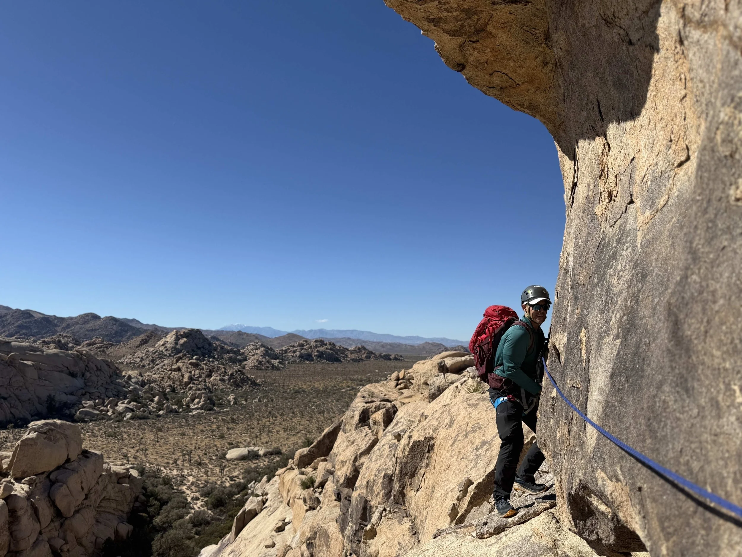 Climber traversing granite rock in Joshua Tree National Park