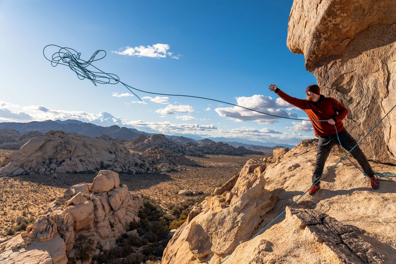 Summit Climbing Guides instructors on a granite formation in Joshua Tree National Park under a clear sky