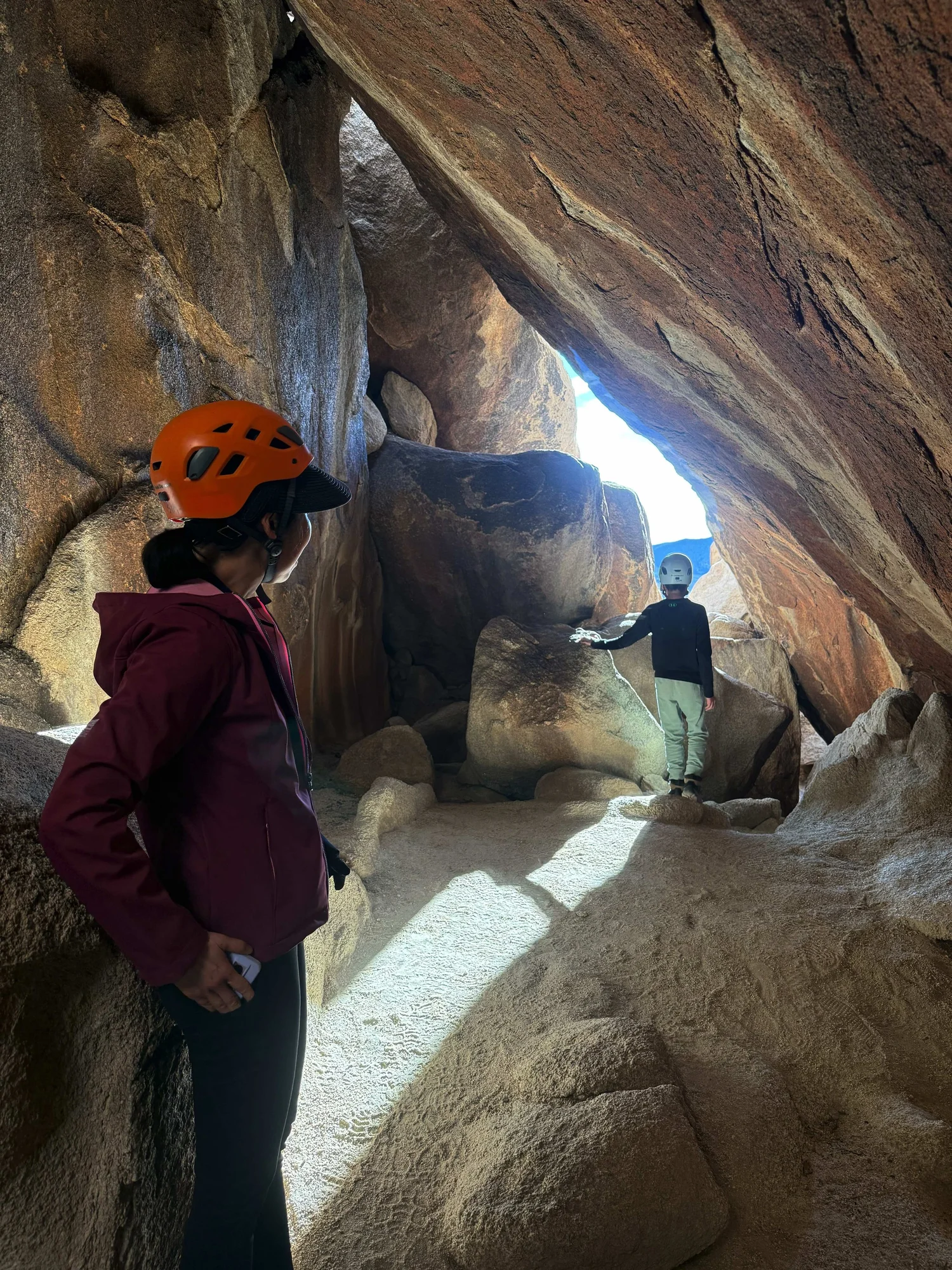 Guides and guests navigating a wide granite passage on an S1 Squeeze Scale adventure