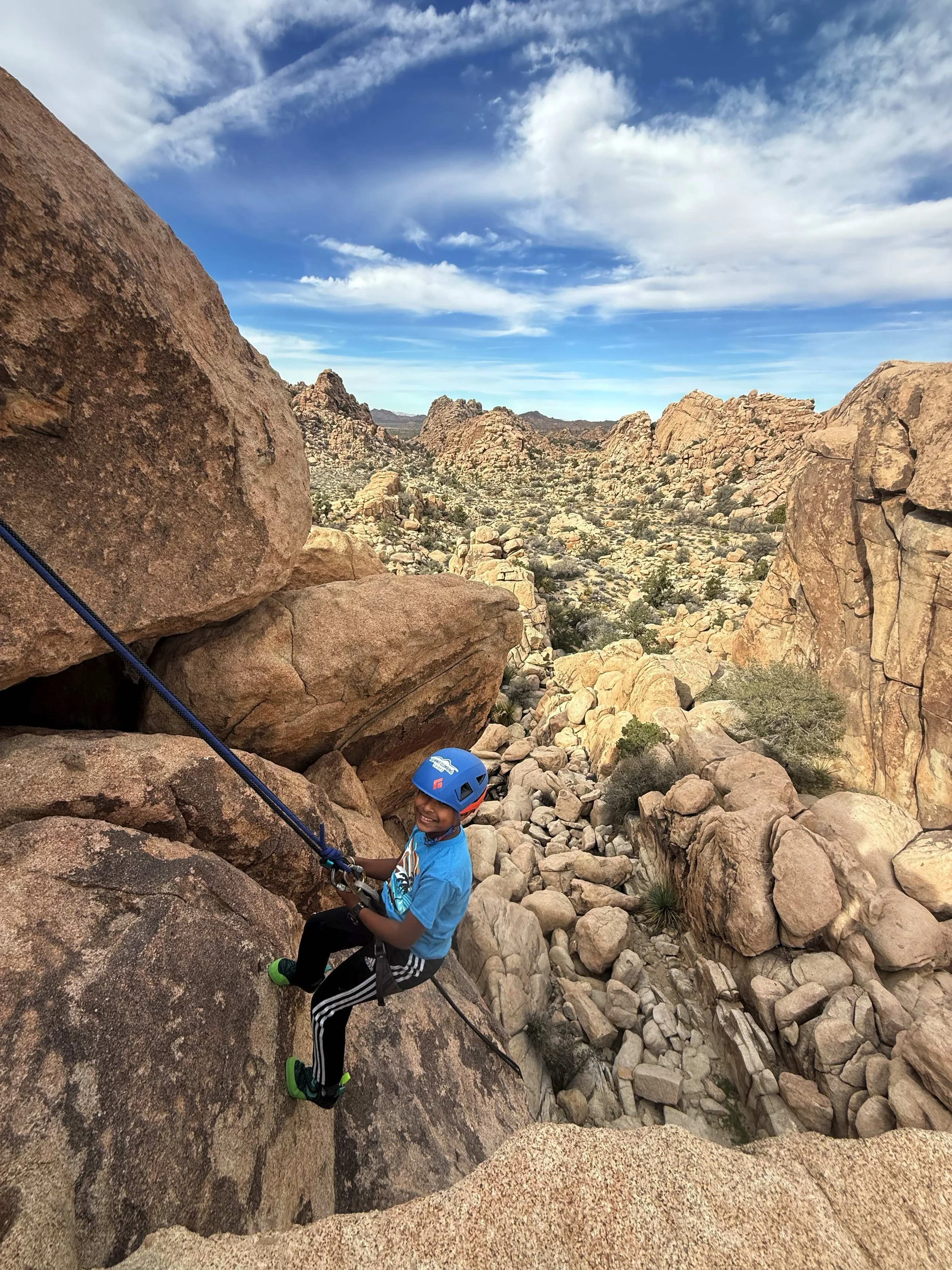 Young boy rappelling in Joshua Tree with Summit Climbing Guides
