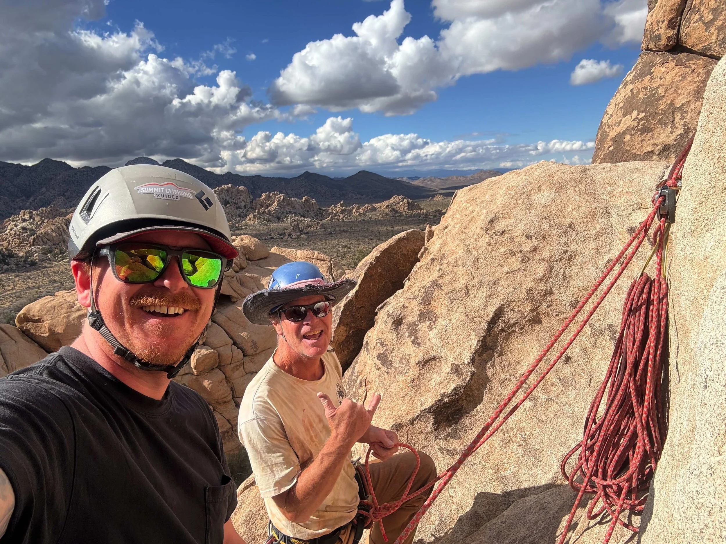 Two guys taking a climbing selfie at Joshua Tree — bachelor crew adventure