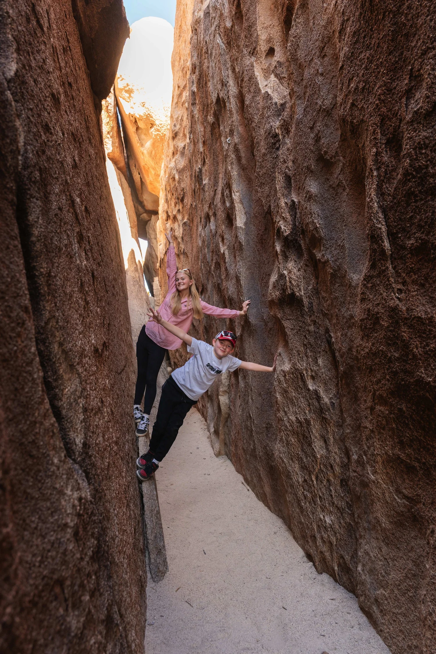 Kids exploring the Main Hall of Horrors corridor with Summit Climbing Guides in Joshua Tree