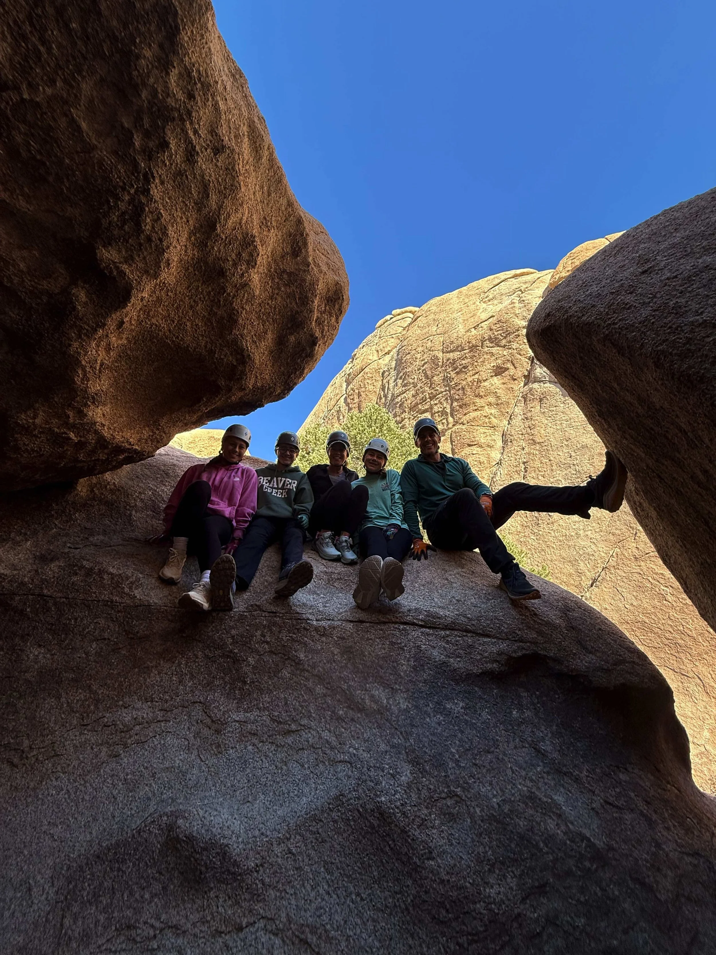 Family celebrating their Chasm of Doom guided adventure with Summit Climbing Guides in Joshua Tree