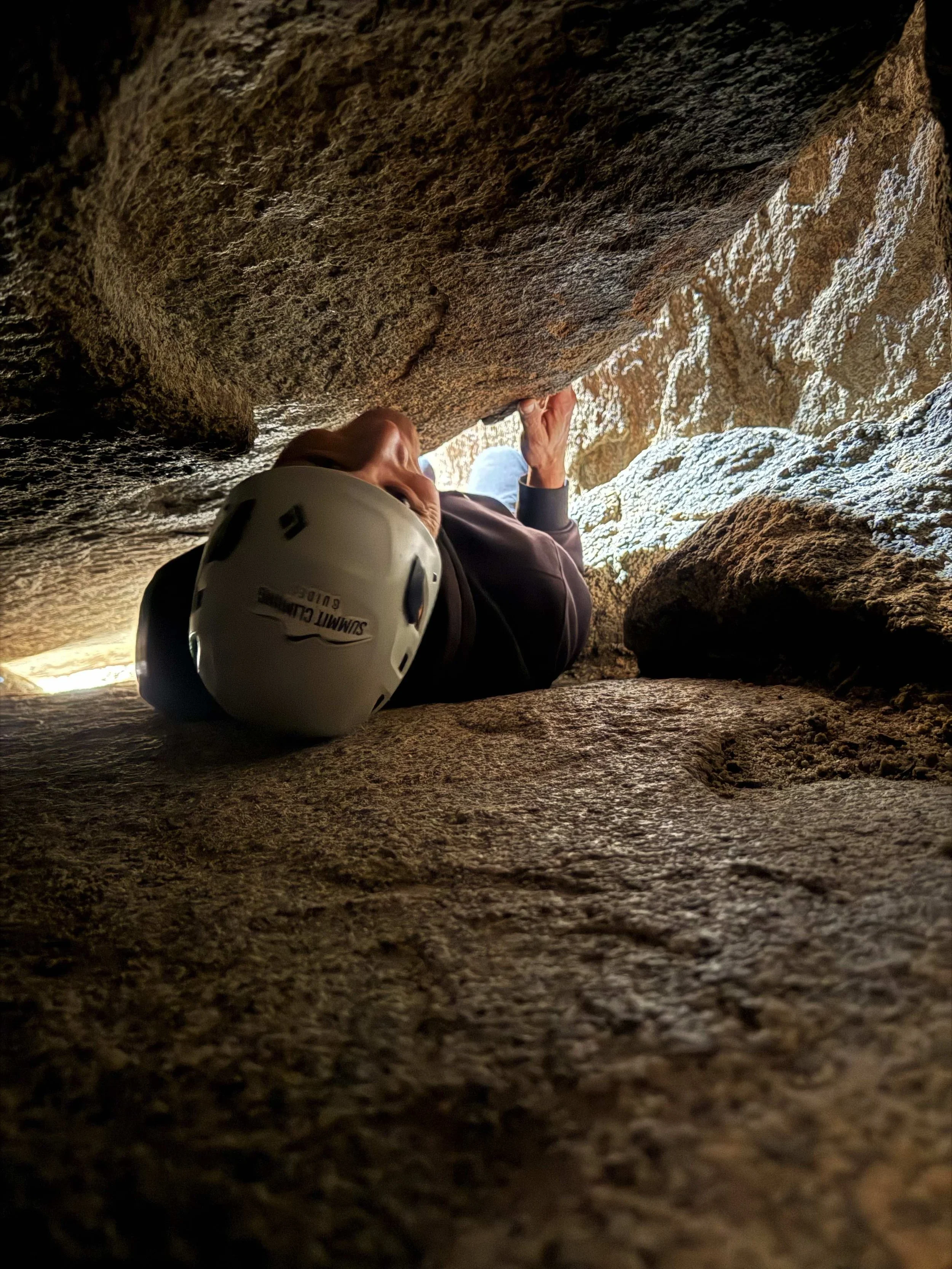 Summit Climbing Guides guest deep inside a tight cave passage in Joshua Tree National Park