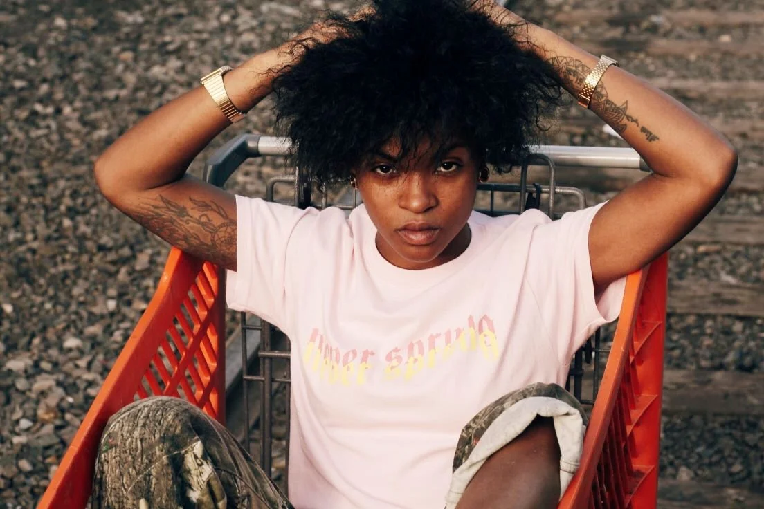 young woman sitting  in orange shopping cart