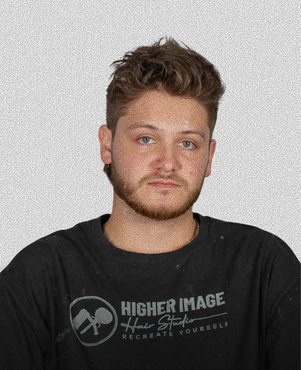 Portrait of a young man with light skin, curly brown hair, and a beard, wearing a black T-shirt.