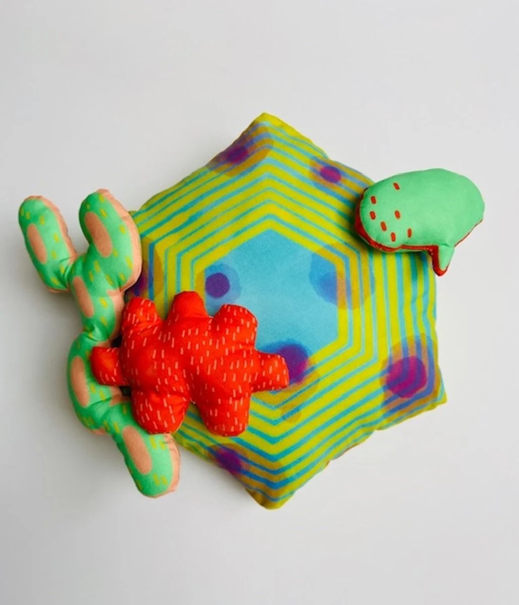 Colorful hand sewn piece with custom fabric designed from the artists prints