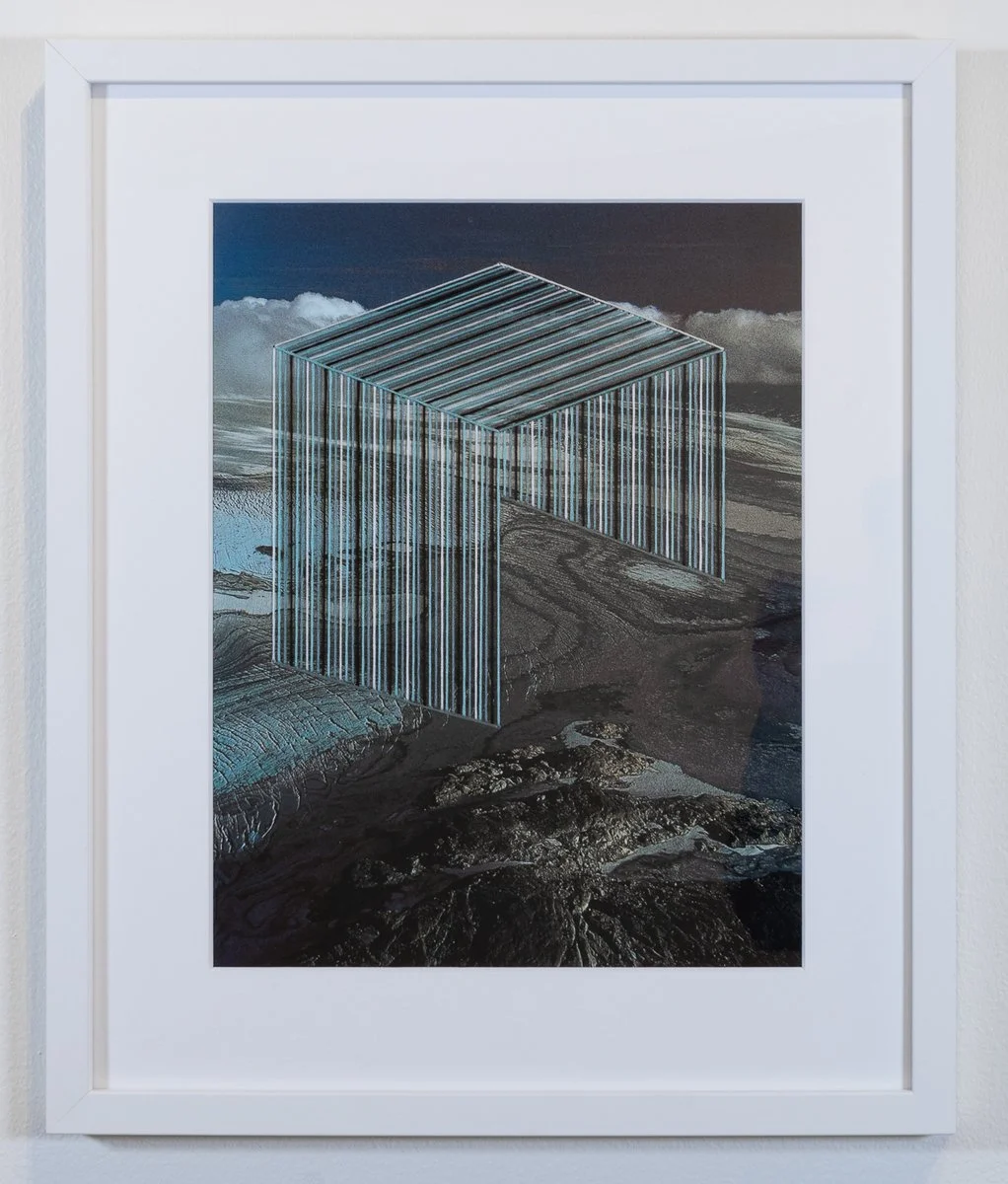 Embroidered collage of landscape scene with an arch of embroidery on found paper ephemera, framed in a white frame