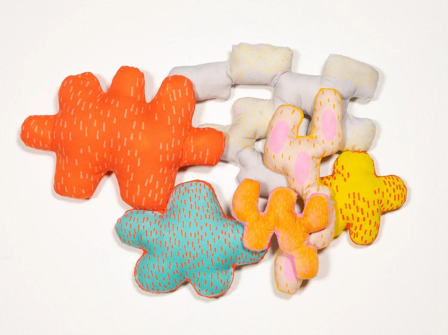 Colorful hand sewn piece with custom fabric designed from the artists prints