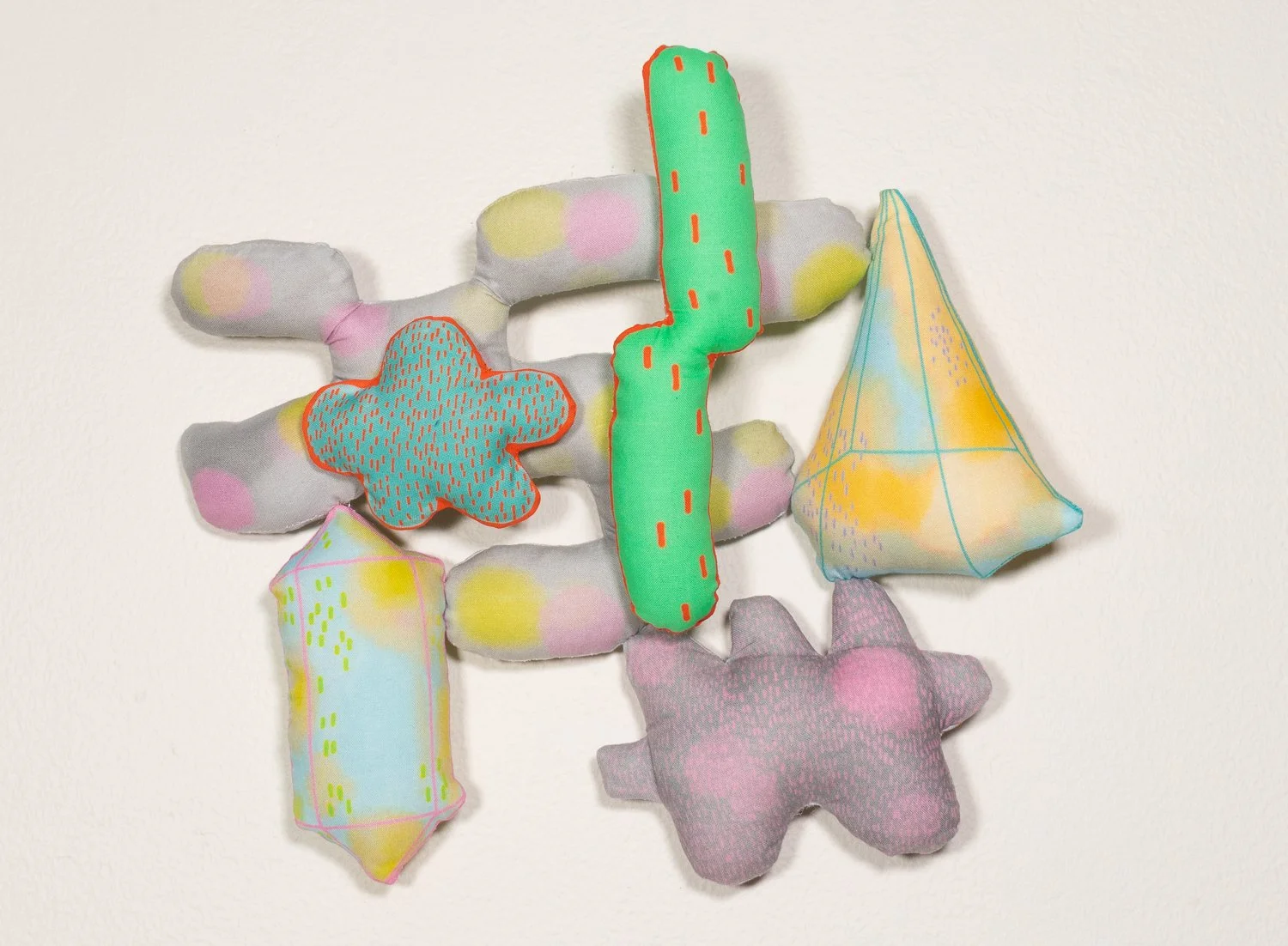 Colorful hand sewn piece with custom fabric designed from the artists prints