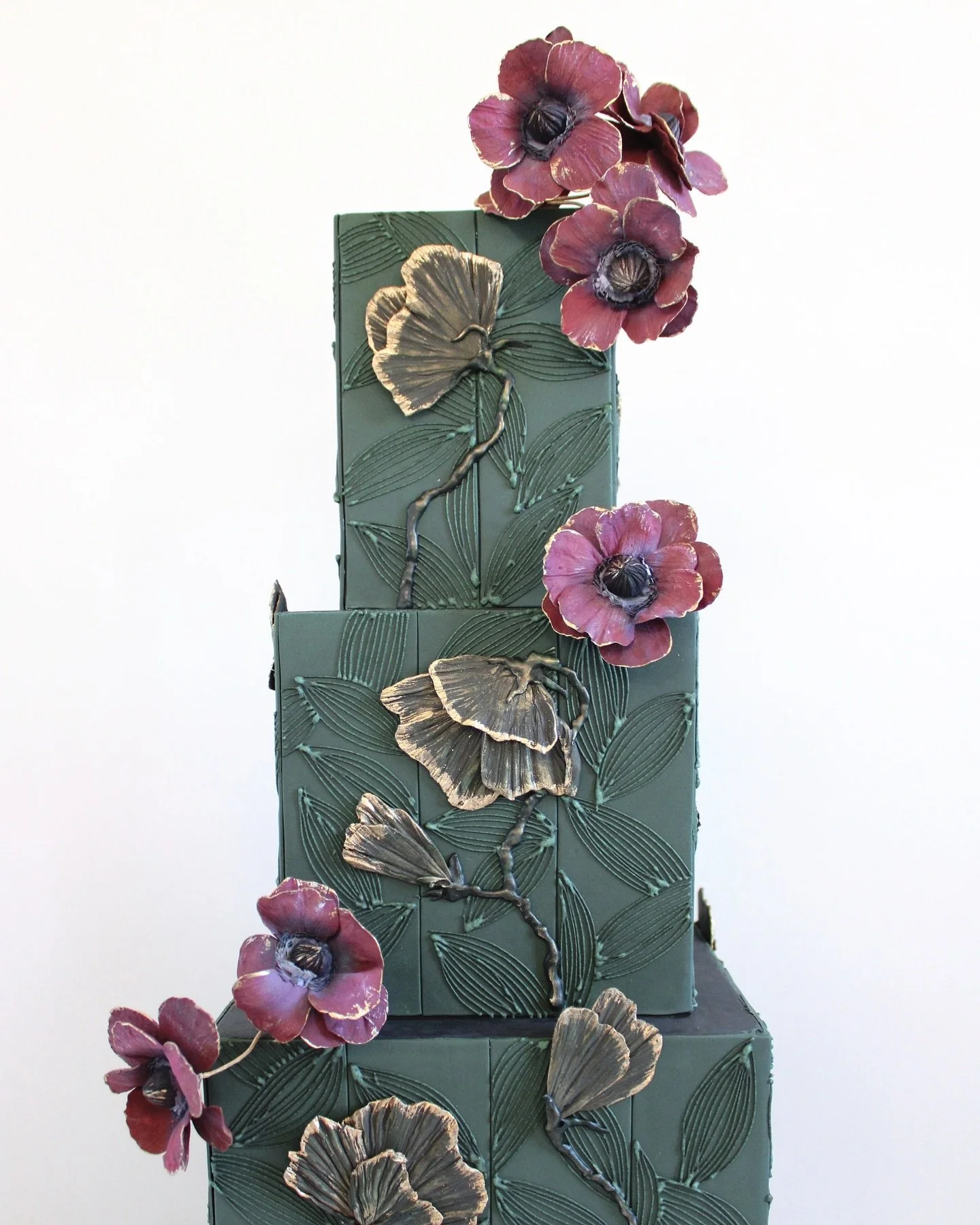 The details really made this one. Clean lines, hand-cut fondant tiles, 6hrs of piping and highlighting a favorite bloom of the bride in sugar.

The approach for decorating a cake can happen in one fell swoop or in intervals of work with periods of re