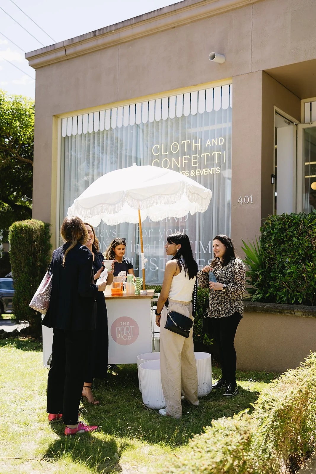 Guests enjoying drinks around The Cart Co beverage cart at an outdoor corporate event in Melbourne.