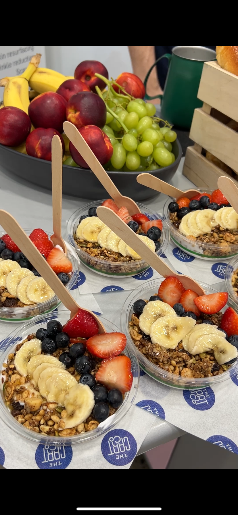 Yoghurt and granola bowls topped with banana, strawberries and blueberries