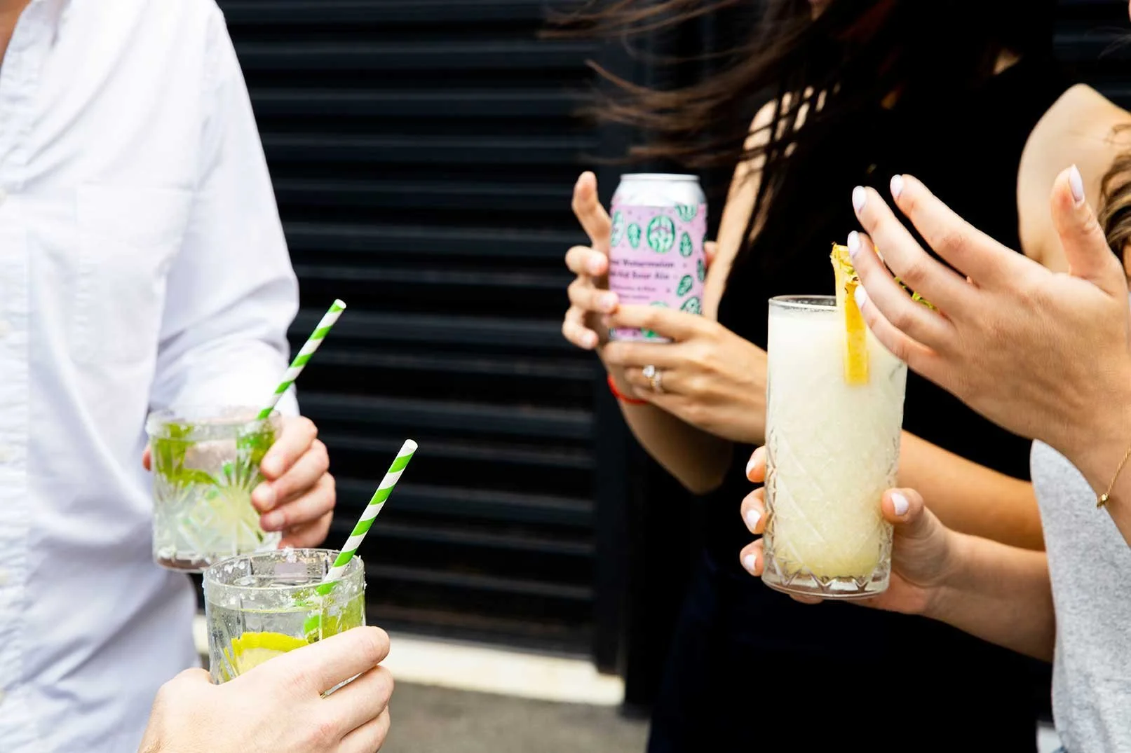 Guests holding refreshing iced drinks and cocktails at a corporate event.