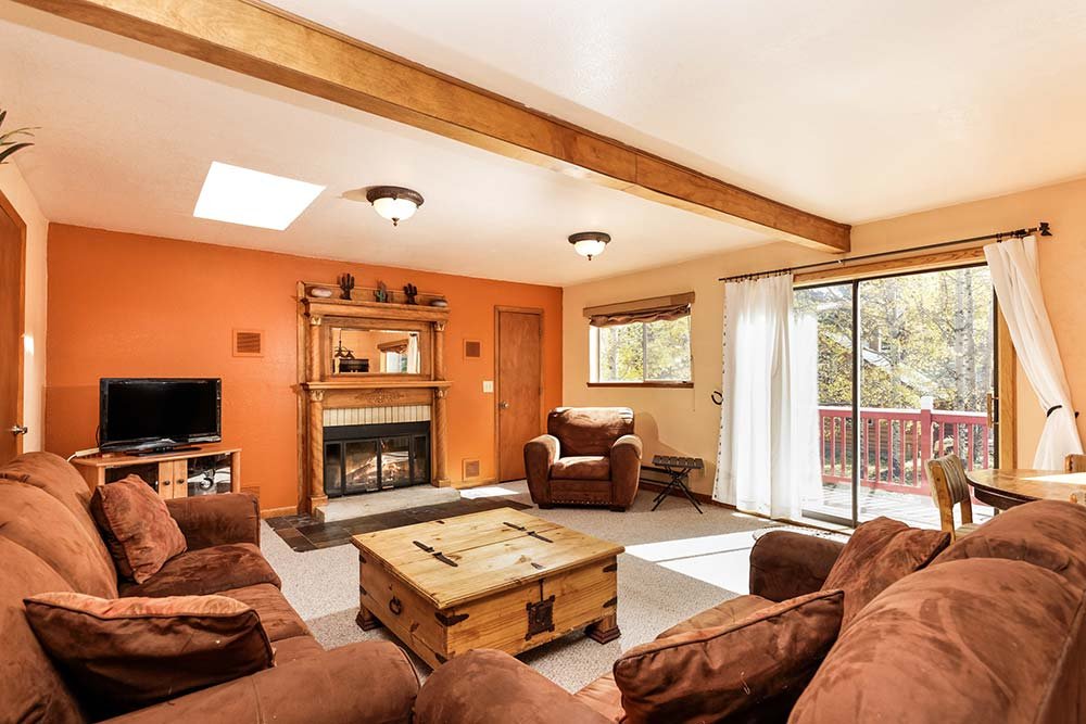 Living room in upper barnhouse suite apartment with wood burning stove