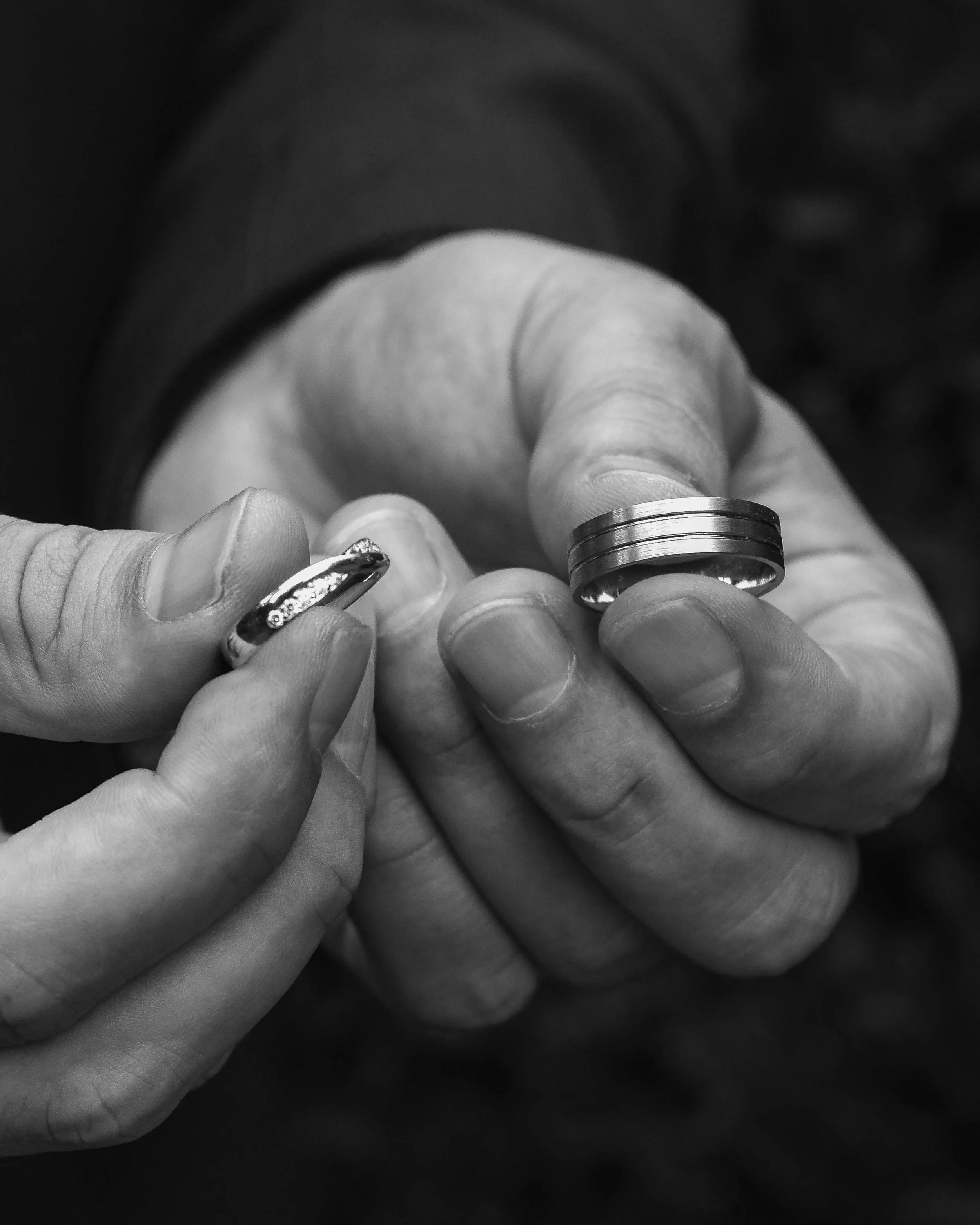 Close up of groom holding wedding rings, Bradford wedding photographer.