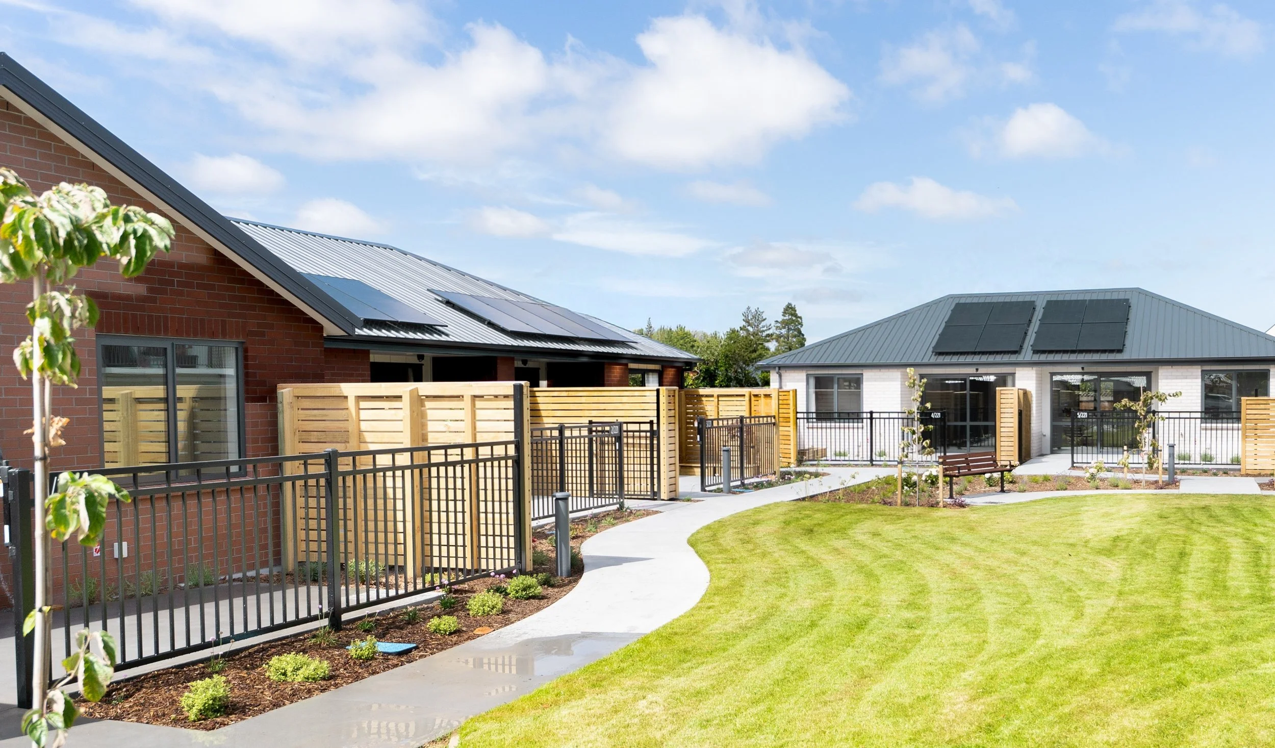 Single-level dwellings with manicured communal paths and grass areas